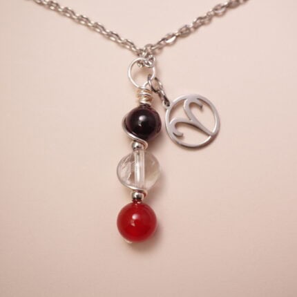 Aries zodiac necklace with amethyst, clear quartz, and red agate gemstones.
