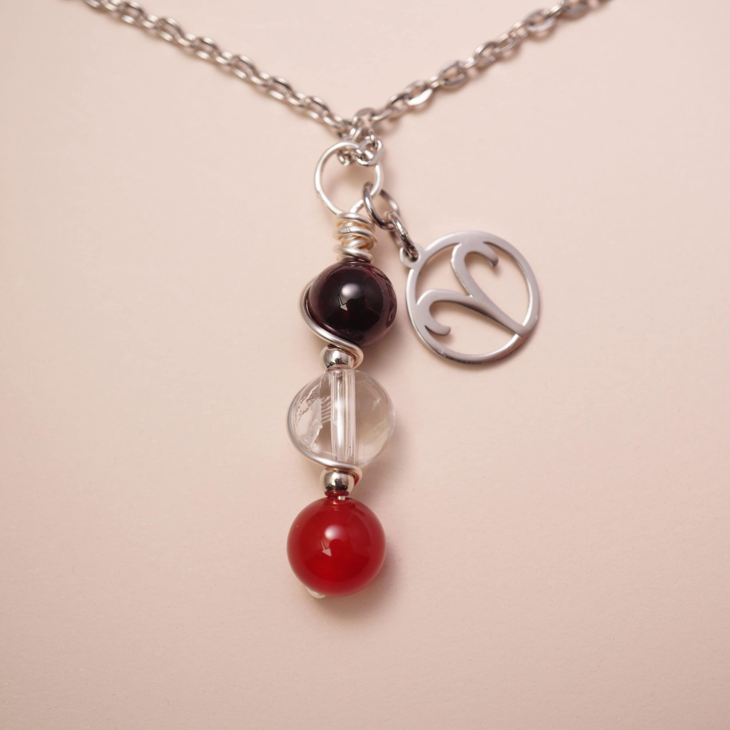 aries-zodiac-necklace-amethyst-clear-quartz-red-agate-main Aries zodiac necklace with amethyst, clear quartz, and red agate gemstones.
