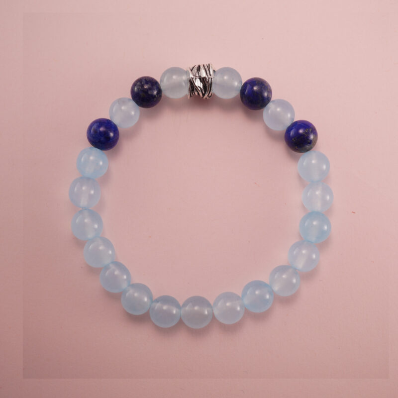 Aquamarine and lapis lazuli bracelet with a silver accent bead, photographed under soft daylight.
