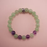 Prehnite and amethyst bracelet with a silver accent bead, photographed under soft daylight.