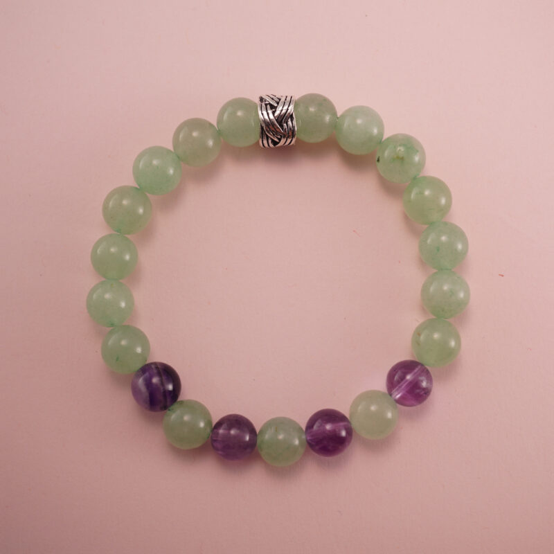 Prehnite and amethyst bracelet with a silver accent bead, photographed under soft daylight.
