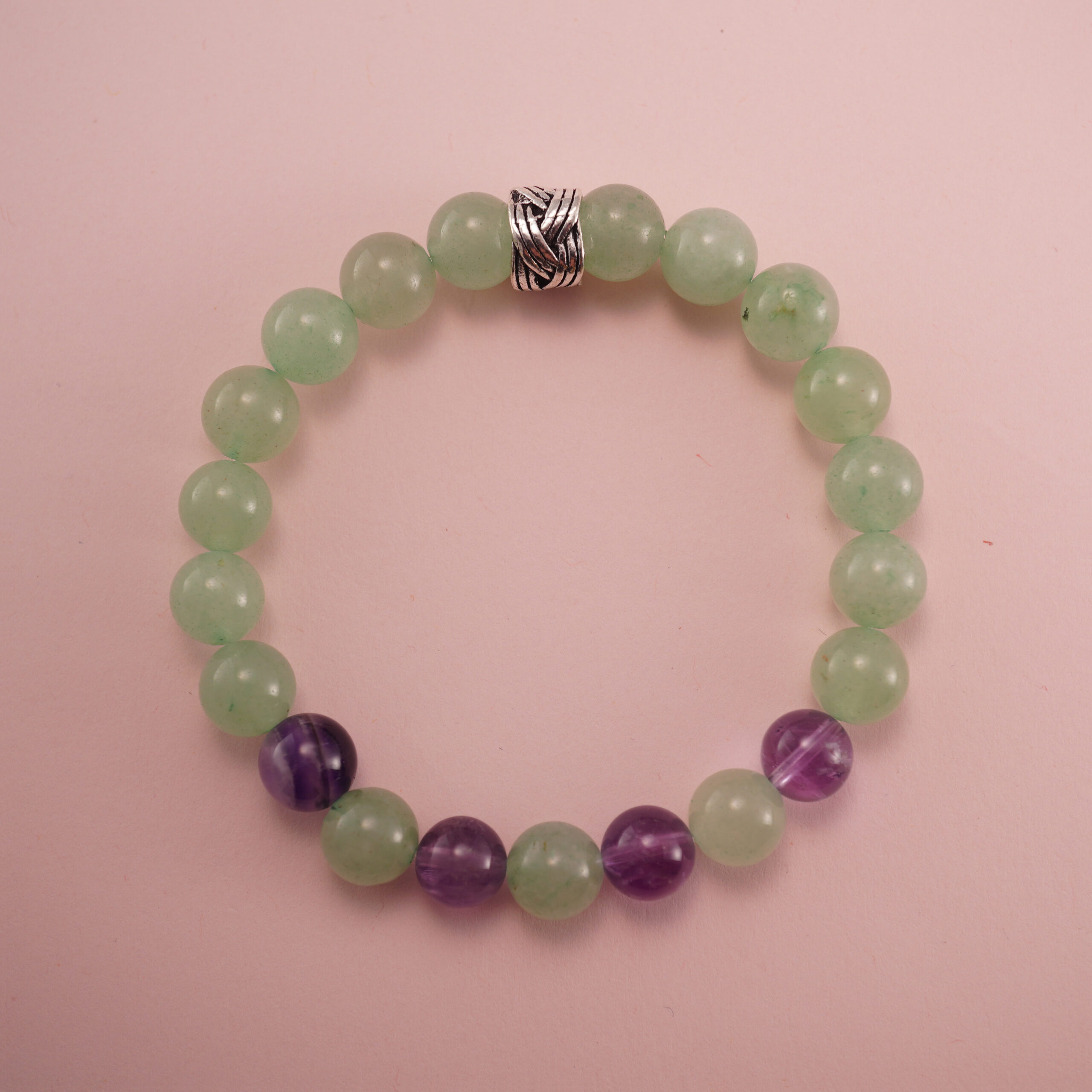 prehnite-and-amethyst-bracelet-with-silver-bead Prehnite and amethyst bracelet with a silver accent bead, photographed under soft daylight.