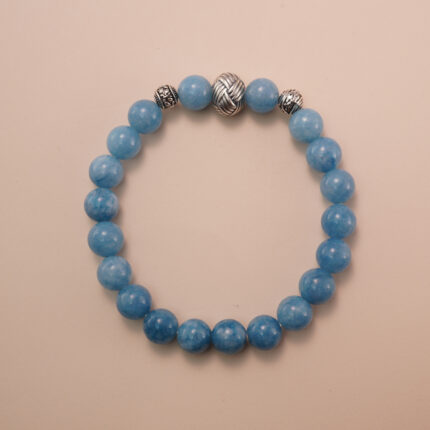 Aquamarine bracelet with silver accent beads, photographed under soft daylight to highlight the serene ocean-blue color and smooth gemstone finish.