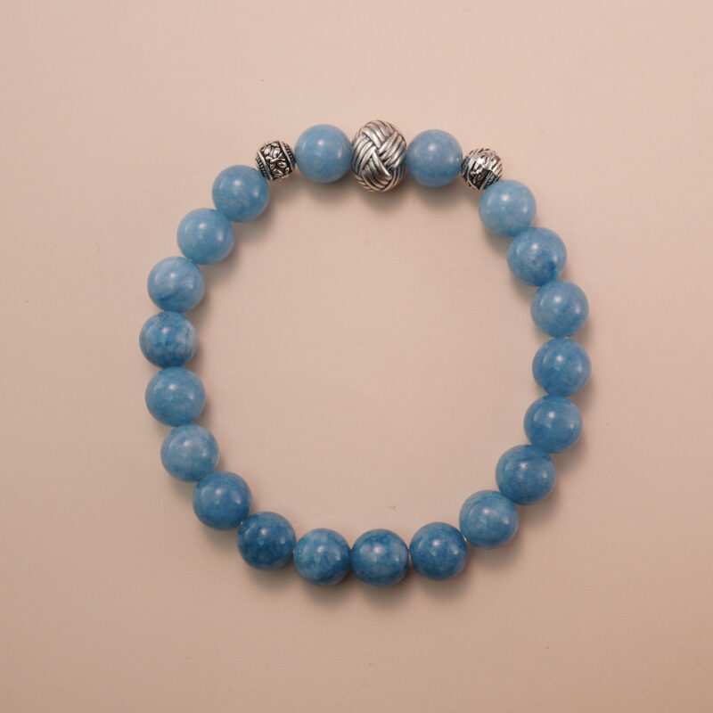 Aquamarine bracelet with silver accent beads, photographed under soft daylight to highlight the serene ocean-blue color and smooth gemstone finish.