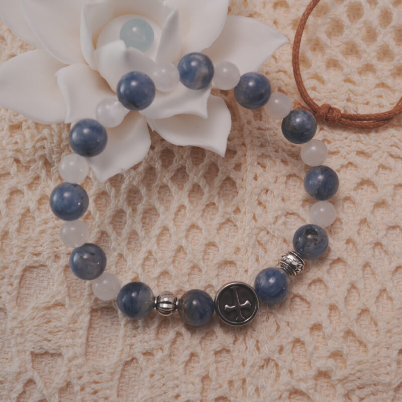 Kyanite and moonstone bracelet displayed in a natural lifestyle setting under soft daylight, highlighting the soothing blue and iridescent white tones.