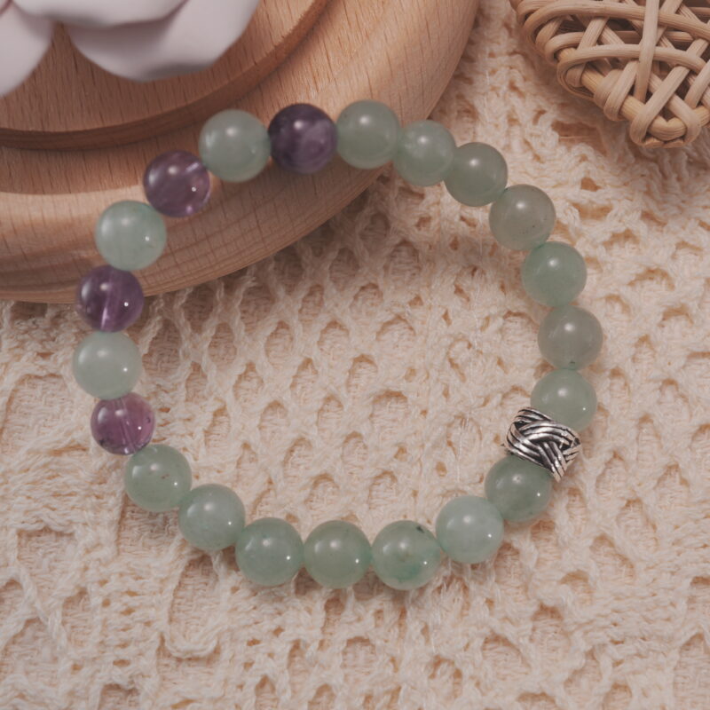 Prehnite and amethyst bracelet shown in a lifestyle setting under natural light, highlighting its calming green and purple tones.