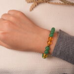 Model wearing green aventurine and citrine bracelet, showing an elegant and uplifting style.