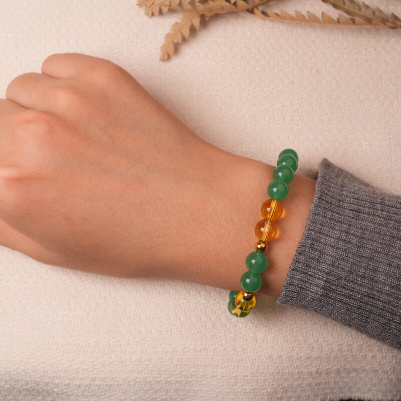 Model wearing green aventurine and citrine bracelet, showing an elegant and uplifting style.