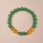 Green aventurine and citrine bracelet symbolizing wealth, good luck, and positive energy.