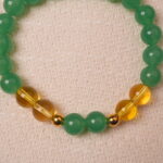 Close-up of green aventurine and citrine beads, showing natural texture and balanced color contrast.