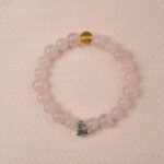 Rose quartz and citrine bracelet with silver heart charm, symbolizing love, happiness, and gentle energy.