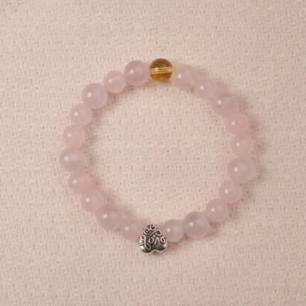 Rose quartz and citrine bracelet with silver heart charm, symbolizing love, happiness, and gentle energy.