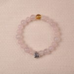 Rose quartz and citrine bracelet with silver heart charm, symbolizing love, happiness, and gentle energy.