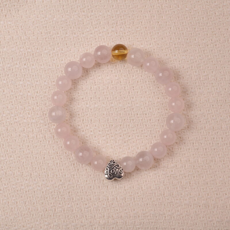 Rose quartz and citrine bracelet with silver heart charm, symbolizing love, happiness, and gentle energy.