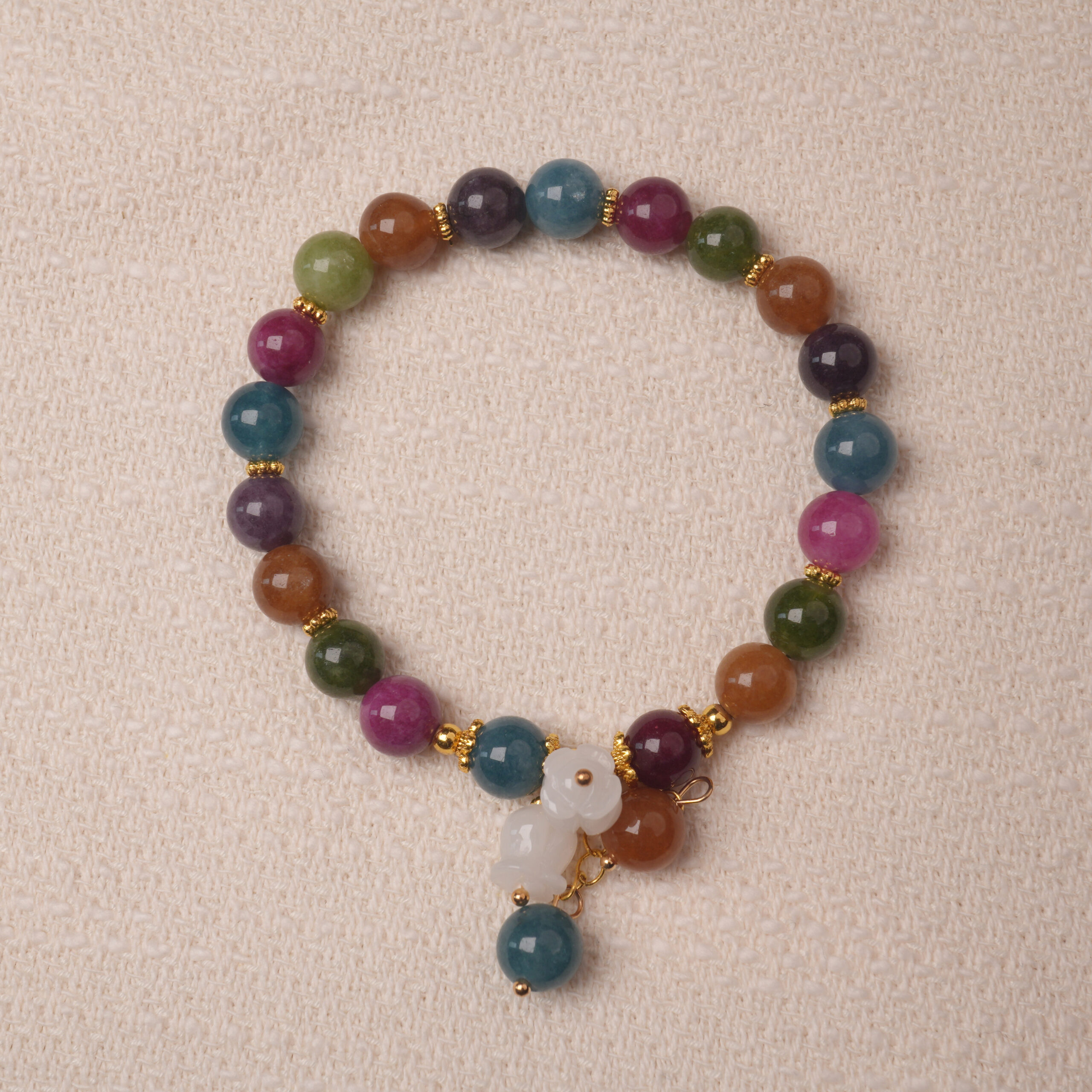 multicolor-tourmaline-gourd-bracelet-main.jpg Multicolor tourmaline bracelet with white gourd charm, symbolizing protection, balance, and good luck energy.