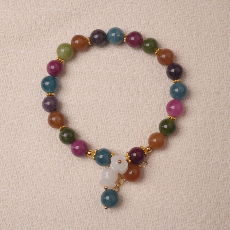Multicolor tourmaline bracelet with white gourd charm, symbolizing protection, balance, and good luck energy.