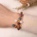 Model wearing multicolor tourmaline bracelet with gourd charm, showing elegant and vibrant style.