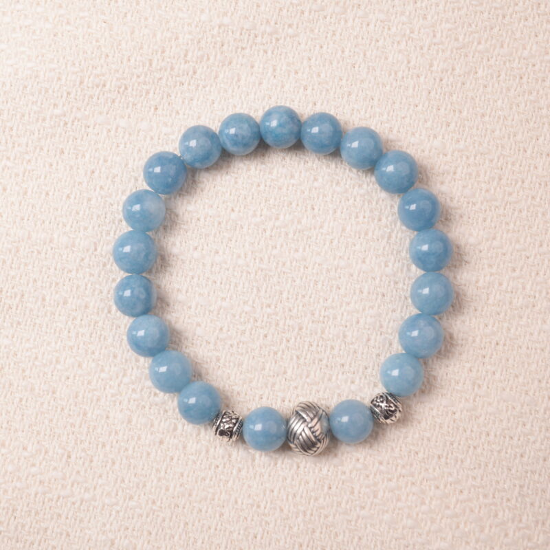 Aquamarine bracelet with silver accent beads, photographed under soft daylight to highlight the serene ocean-blue color and smooth gemstone finish.