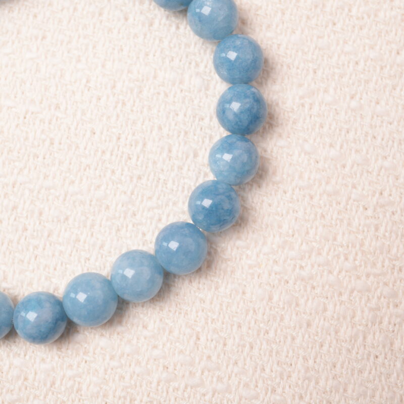 A detailed close-up of the Aquamarine bracelet, highlighting the polished texture of the beads and the silver spacers that complement the light blue color of the gemstones.