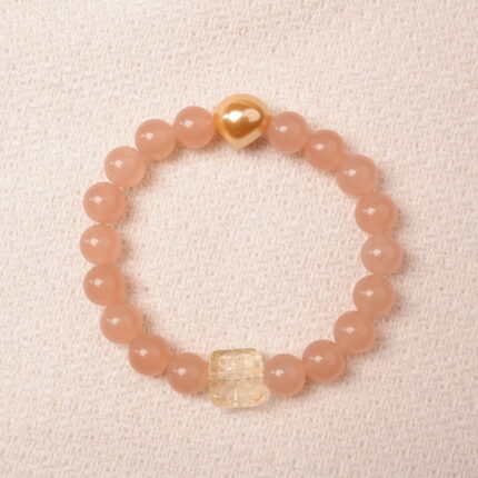 Peach moonstone bracelet with citrine and gold heart bead, symbolizing love, abundance, and gentle feminine energy.