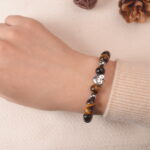 Model wearing tiger eye bracelet, showing grounding and confident energy.