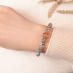 Model wearing moonstone bracelet, showing soft iridescent glow under natural light.