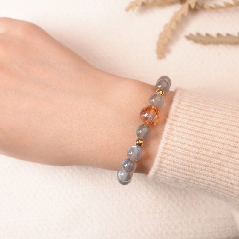 Model wearing moonstone bracelet, showing soft iridescent glow under natural light.
