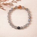 Lifestyle photo of moonstone bracelet placed on beige fabric with a tranquil, elegant vibe.