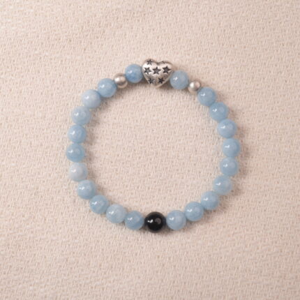 Aquamarine bracelet with silver heart charm and black accent bead, symbolizing calmness and clear communication.