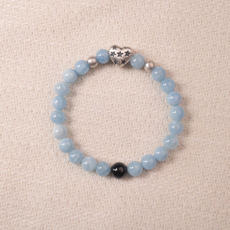 Aquamarine bracelet with silver heart charm and black accent bead, symbolizing calmness and clear communication.