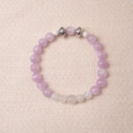 Kunzite and moonstone bracelet featuring soft lavender and milky white beads, symbolizing calm and emotional balance.