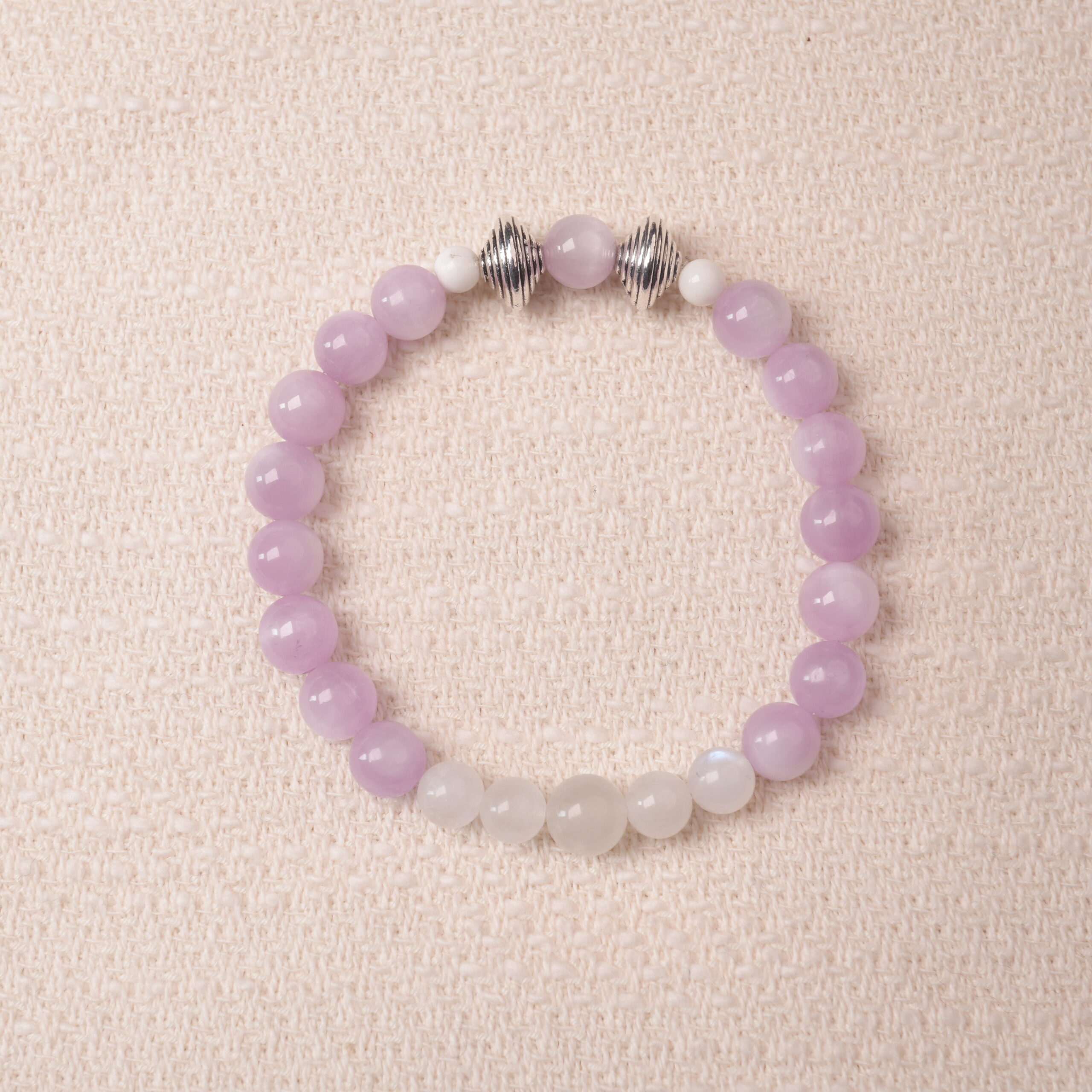 kunzite-moonstone-bracelet-main.jpg Kunzite and moonstone bracelet featuring soft lavender and milky white beads, symbolizing calm and emotional balance.