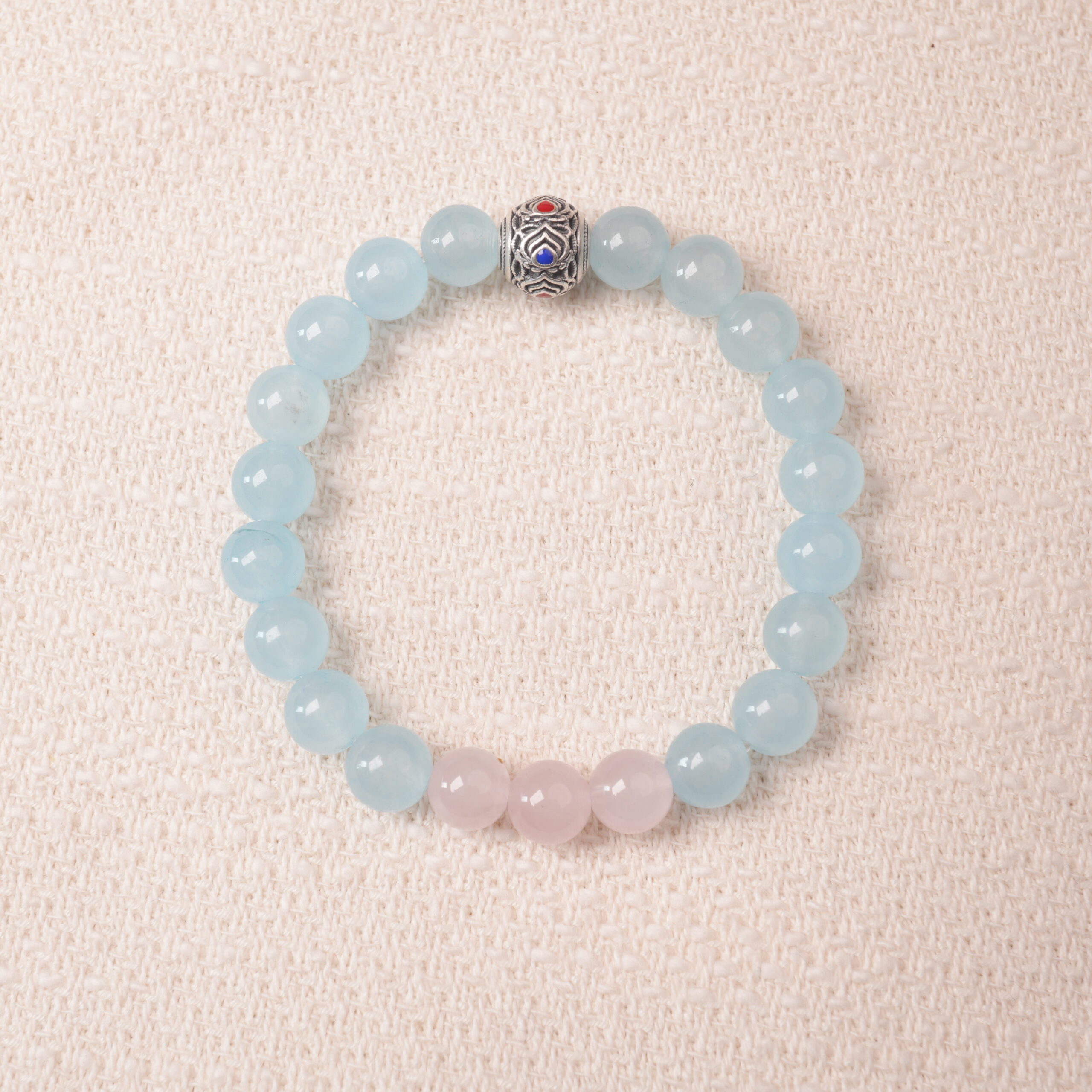 aquamarine-rose-quartz-bracelet-main.jpg Aquamarine and rose quartz bracelet with blue and pink beads, symbolizing love, peace, and open communication.