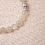 Close-up of moonstone beads showing natural sheen and smooth round texture.