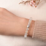 Model wearing moonstone bracelet with silver accent bead, showing elegant and gentle style.
