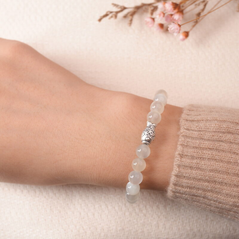 Model wearing moonstone bracelet with silver accent bead, showing elegant and gentle style.