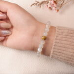 Back view of moonstone bracelet showing translucent white glow and natural shine.