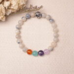 Lifestyle photo of jade energy bracelet placed on fabric, radiating calm and gentle energy.
