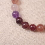 Close-up of strawberry quartz bracelet showing natural inclusions and delicate gradient tones.
