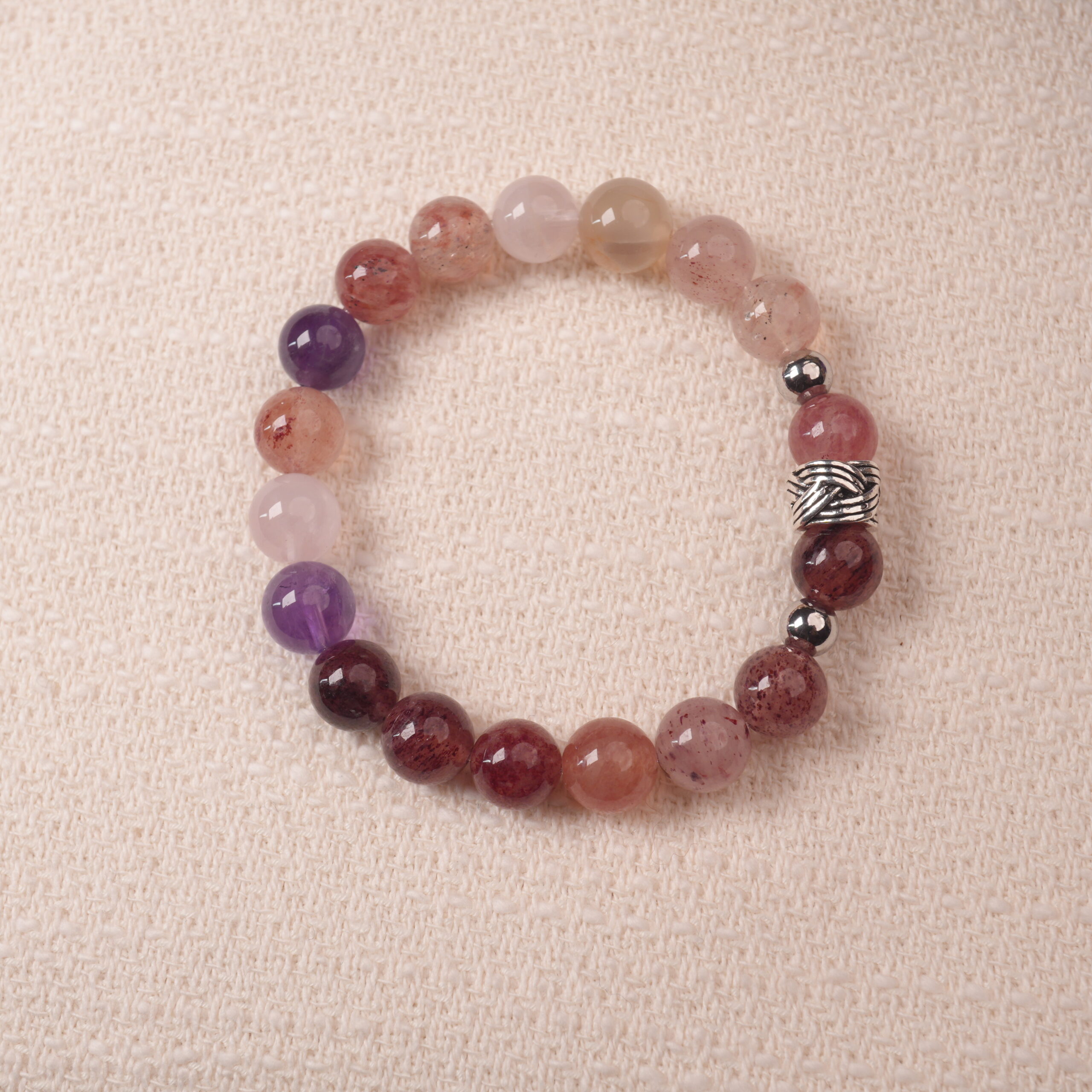 strawberry-quartz-amethyst-bracelet-main.jpg Strawberry quartz and amethyst bracelet with natural pink and purple tones, symbolizing love and positivity.