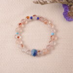 Lifestyle photo of Red Hematoid Quartz bracelet placed on soft fabric, radiating balance and vitality.