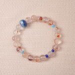 Red Hematoid Quartz bracelet featuring natural red inclusions within clear quartz, symbolizing grounding and passion.