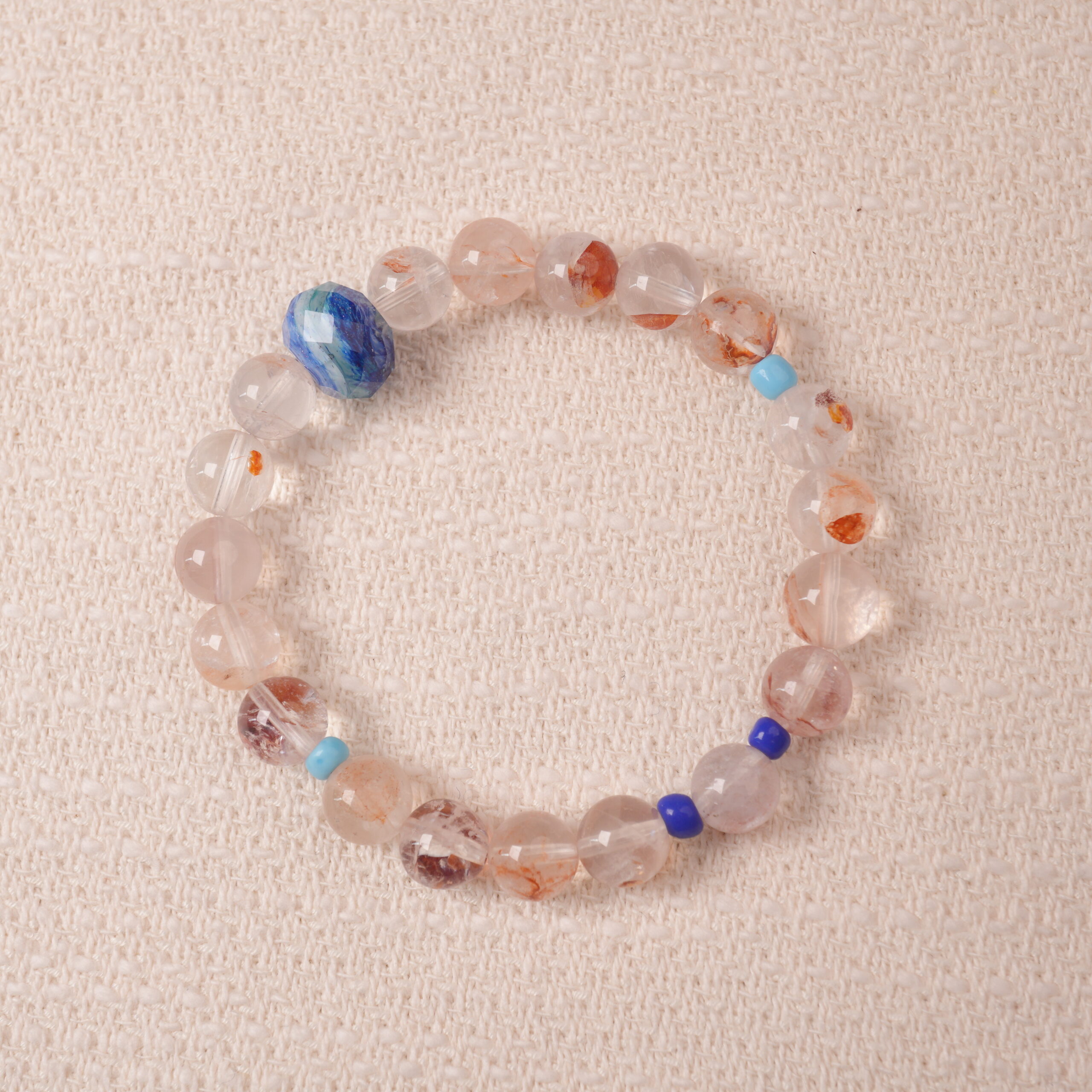 red-hematoid-quartz-bracelet-main.jpg Red Hematoid Quartz bracelet featuring natural red inclusions within clear quartz, symbolizing grounding and passion.