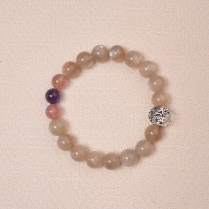 Moonstone, Amethyst, and Strawberry Quartz bracelet with a silver flower accent bead, designed for tranquility and emotional healing.