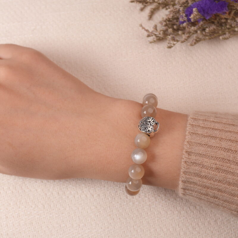Model wearing Moonstone, Amethyst, and Strawberry Quartz bracelet, showcasing a calming blend of soft pastel beads.
