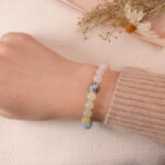 Model wearing Tranquil Harmony bracelet, showing a beautiful combination of soft pastel-colored beads.