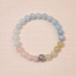 Tranquil Harmony bracelet with aquamarine, rose quartz, and green jade beads, featuring a silver accent bead in the center.