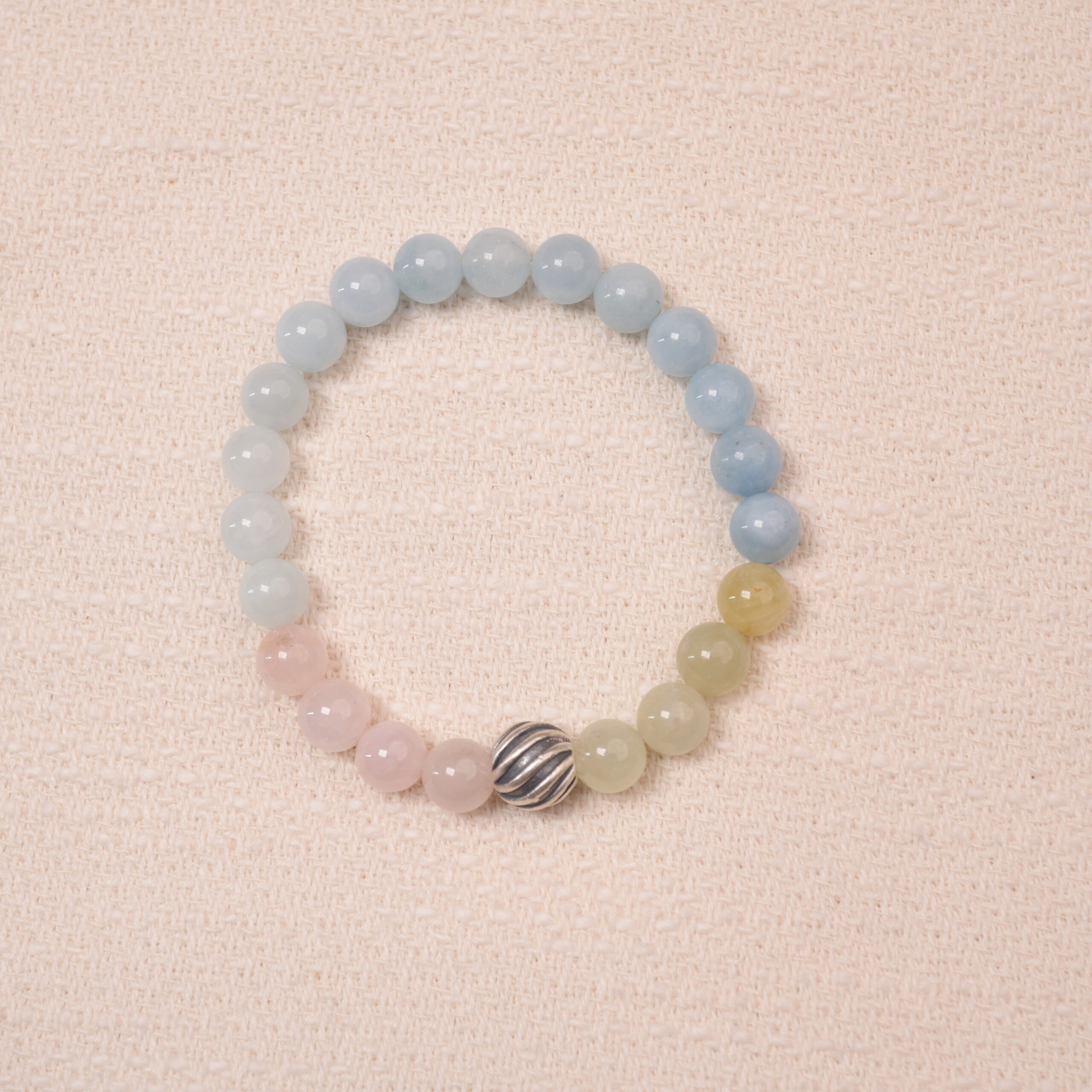 tranquil-harmony-bracelet-main Tranquil Harmony bracelet with aquamarine, rose quartz, and green jade beads, featuring a silver accent bead in the center.
