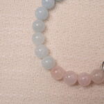 Close-up of Tranquil Harmony bracelet, showcasing the smooth, polished beads of aquamarine, rose quartz, and green jade.