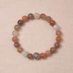 A stunning multicolor Moonstone bracelet with a variety of pastel hues, accented with a silver bead for added elegance. This bracelet combines soothing energy and the healing properties of Moonstone, making it perfect for balance and calm.